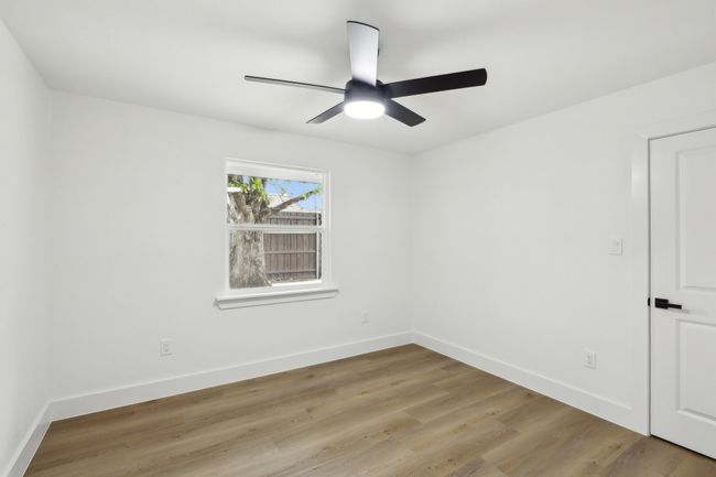 Spare room with a ceiling fan, baseboards, and light wood-style floors | Image 16