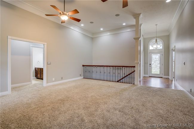 Main living room and stairs to basement | Image 10