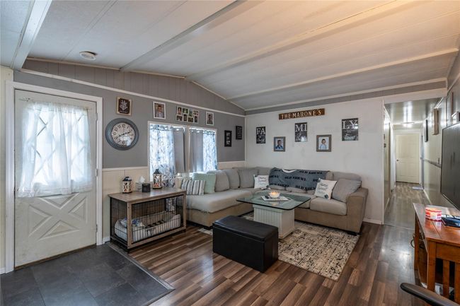 Living room with wood finished floors and wainscoting | Image 7
