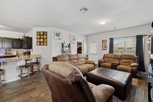 Living area featuring dark wood-vinyl finished floors | Image 22
