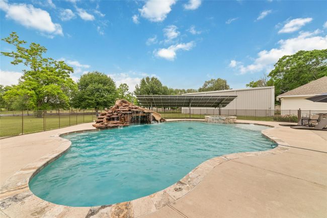 Tucked away on 1.5 serene acres in Manvel, this distinctive property is built for the way you want to live. The flexible floorpan allows between 4 to 6 bedrooms, 2.5 baths, a 2-car garage, in-ground pool, plus a 60'x30' insulated shop. | Image 43
