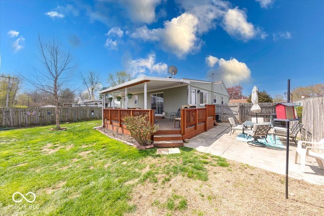back of home featuring a paved side patio for outdoor entertaining or child activities | Image 7