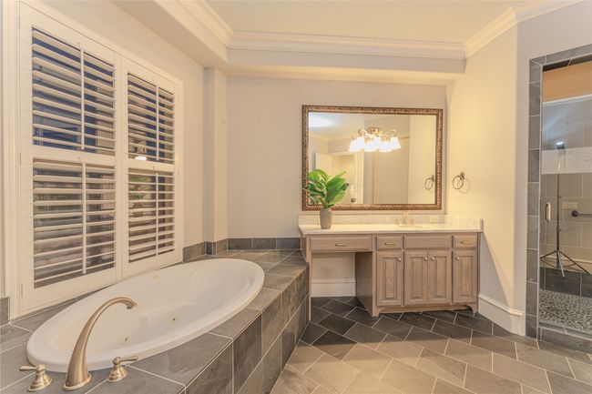 Full bathroom with ornamental molding, a whirlpool tub, vanity, a shower stall, and a chandelier | Image 24