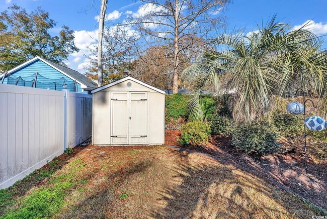 View of yard featuring a sunroom, ceiling fan, and a patio area | Image 35