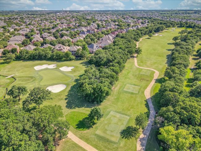 Aerial view of residential area with a golf club and a tree filled landscape | Image 40