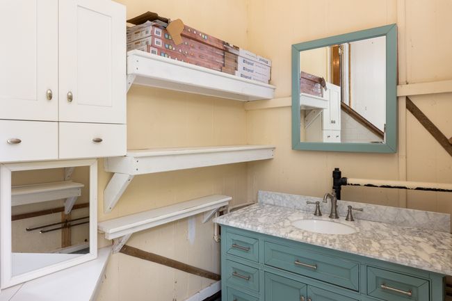 Downstairs bathroom with storage area. | Image 12