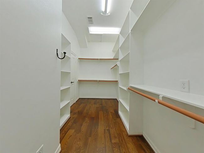 Spacious walk-in closet with ample shelving and hanging space, perfect for organizing your wardrobe. | Image 22
