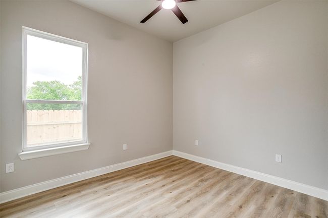 Unfurnished room with baseboards, ceiling fan, and wood finished floors | Image 25