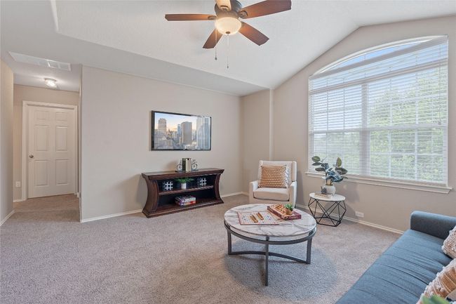 Living area featuring plenty of natural light, carpet, a ceiling fan, and lofted ceiling | Image 24