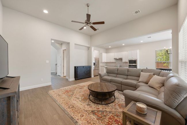 Living room featuring recessed lighting, light wood-style flooring, ceiling fan, and baseboards | Image 4