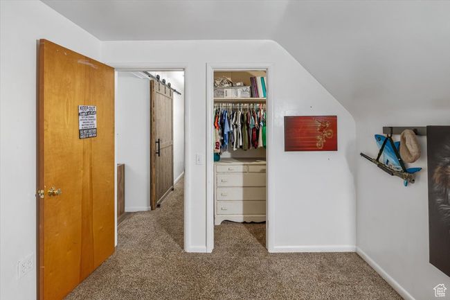 Spacious closet featuring carpet and lofted ceiling | Image 30