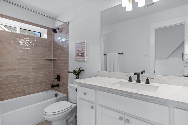 Full bathroom with toilet, tiled shower / bath combo, and vanity | Image 31