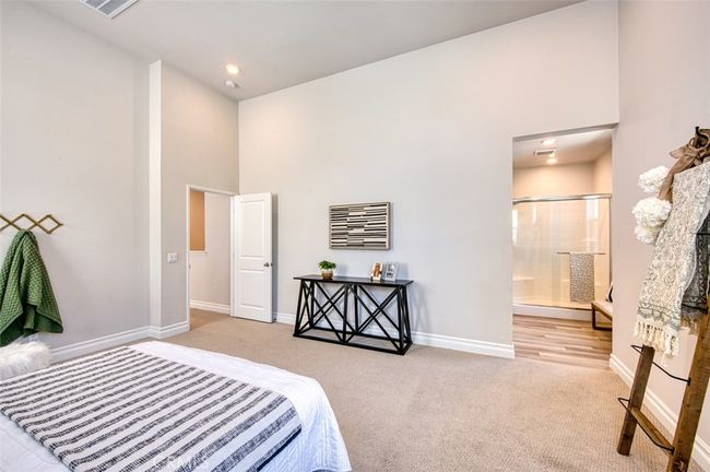 Bright and spacious primary bedroom with high ceilings, shiplap accents and en-suite bathroom. | Image 16