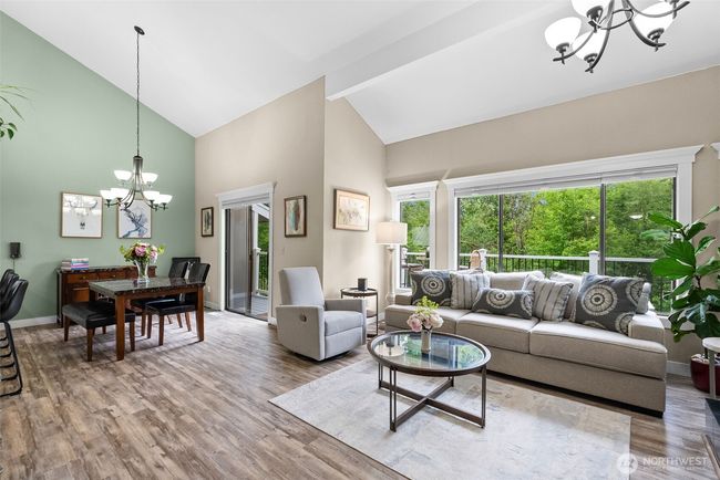 Main floor living room looking from entrance hallway towards dining room and deck | Image 8
