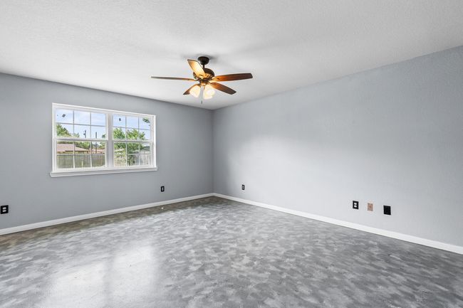 Unfurnished room with ceiling fan and a textured ceiling | Image 29