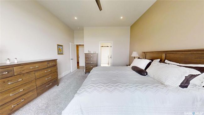 Bedroom with light colored carpet, ensuite bath, recessed lighting, and ceiling fan | Image 19