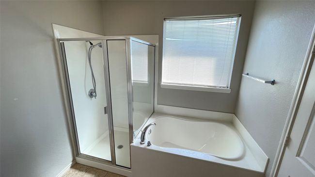 Bathroom with a shower stall, a bath, plenty of natural light, and tile patterned floors | Image 18