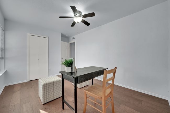 Office with a ceiling fan and wood finished floors | Image 13