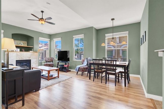 Living area with baseboards, ceiling fan, and a fireplace | Image 9