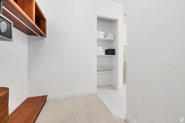 Spacious closet with light tile patterned flooring | Image 24