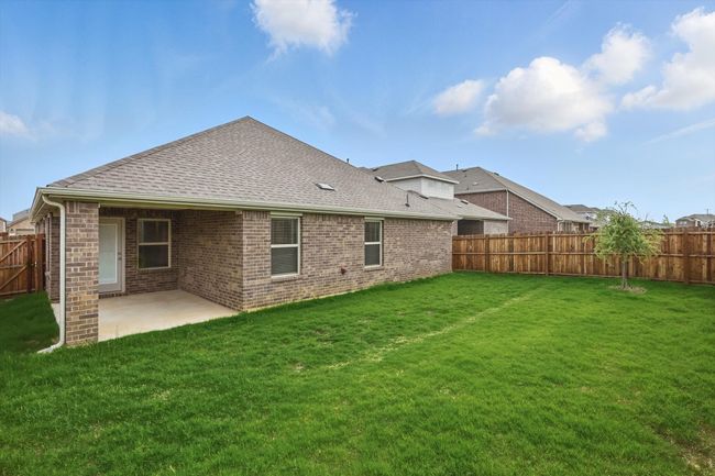 Back of house with a fenced backyard, a patio, roof with shingles, and brick siding | Image 29