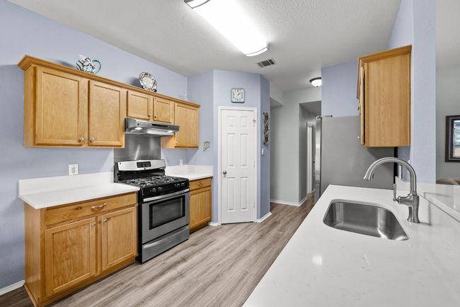 Kitchen open to family room with appliances with stainless steel finishes | Image 7