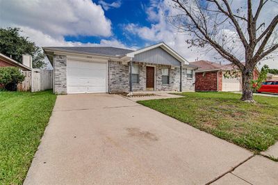 Single story home featuring a garage and a front lawn | Image 2