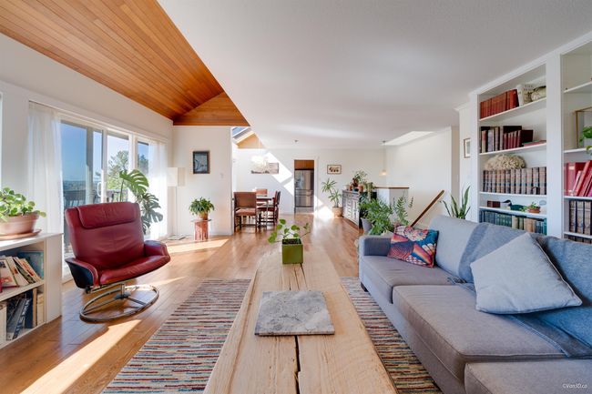 Living room with built in features, wood finished floors, and lofted ceiling | Image 16