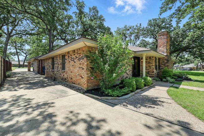 View of side of property featuring a chimney and brick siding | Image 26