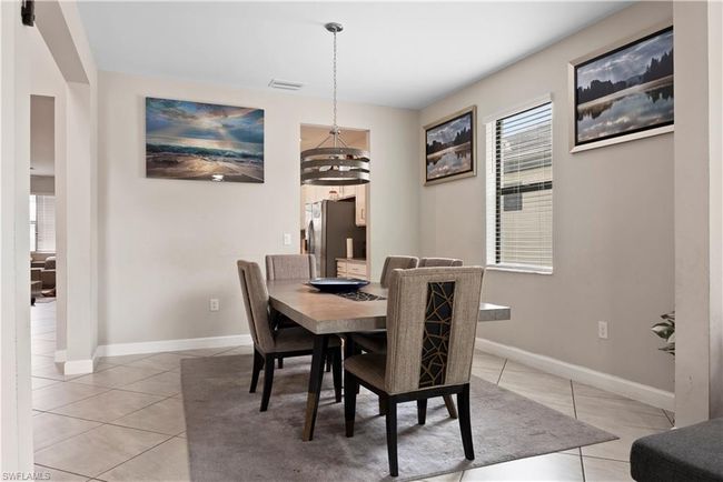 Dining room with baseboards, visible vents, an inviting chandelier, and light tile patterned floors | Image 9