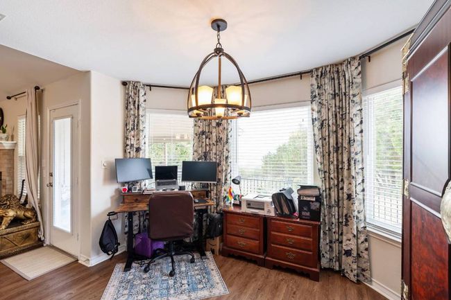 Office space featuring plenty of natural light, baseboards, wood finished floors, and a chandelier | Image 20
