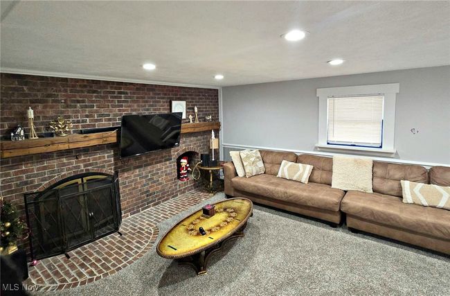 Living room featuring a brick fireplace and recessed lighting | Image 25