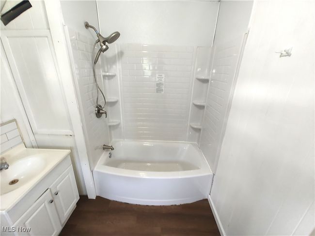 Bathroom featuring wood finished floors, vanity, and bathing tub / shower combination | Image 32