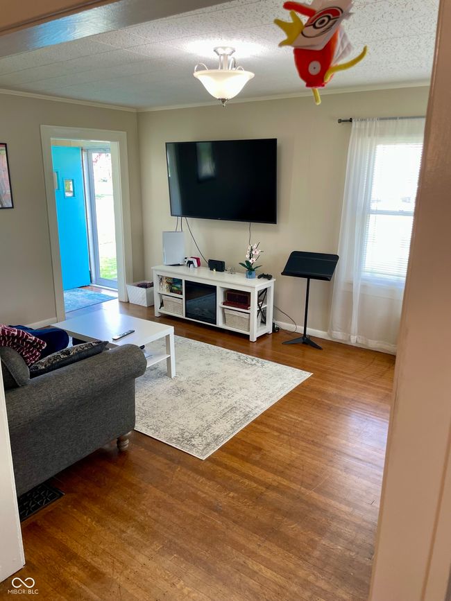 living room featuring ornamental molding and wood finished floors | Image 20