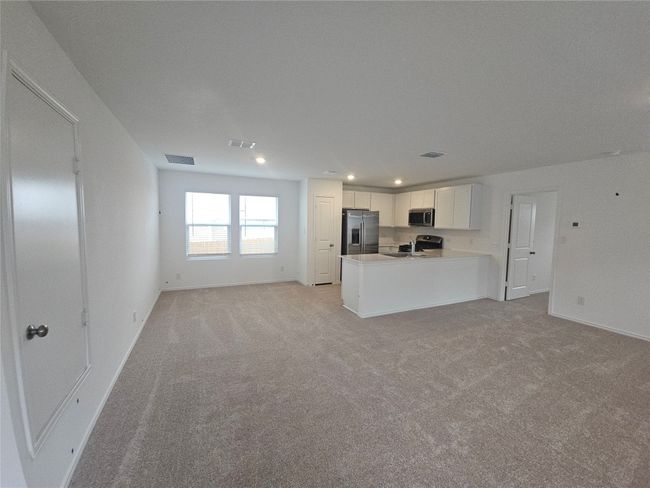 Unfurnished living room featuring light colored carpet, recessed lighting, and baseboards | Image 16