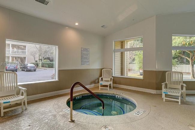 Sitting room with vaulted ceiling, plenty of natural light, and a jacuzzi | Image 25