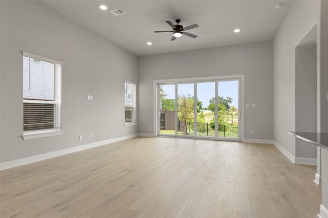 Empty room featuring ceiling fan, light wood-style flooring, and recessed lighting | Image 11