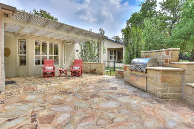 Close up of the pergola seating area and grill station. | Image 25