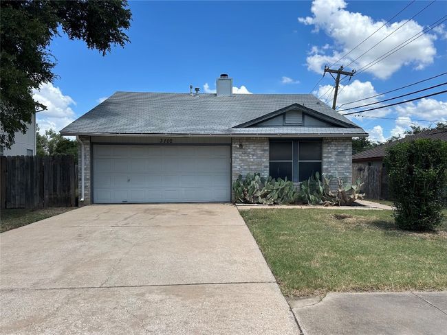 Ranch-style house featuring a garage, driveway, a chimney, and roof with shingles | Image 33