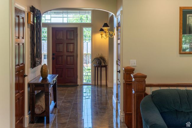 Entrance foyer with arched walkways and dark marble finish floors | Image 16