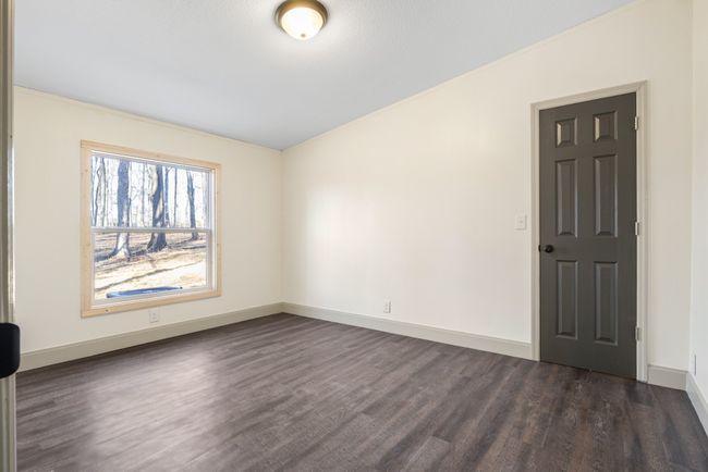 Both secondary bedrooms offer peaceful views of the wooded backyard, creating a serene and private retreat. Wake up to the sights and sounds of nature right outside your window! This bedroom has a walkin closet | Image 9