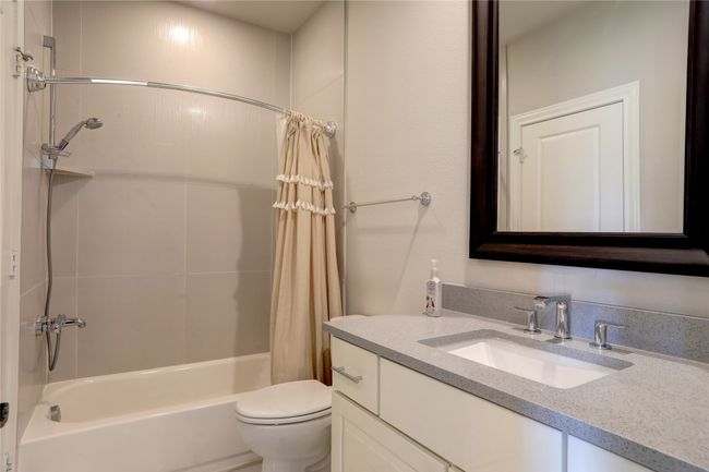 Full bath with vanity, shower / bath combination with curtain, and toilet | Image 22