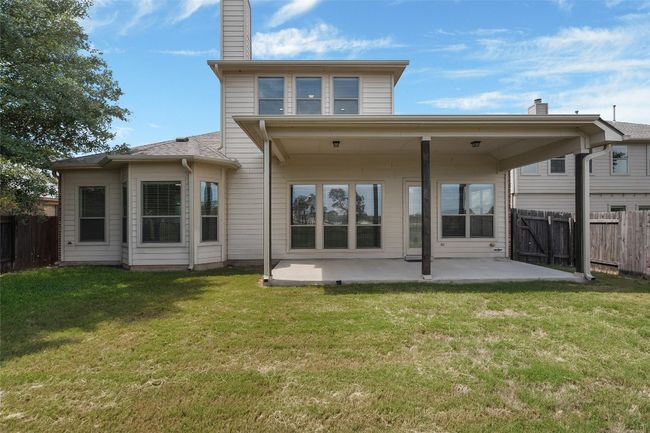 Rear view of house with a patio and a chimney | Image 39
