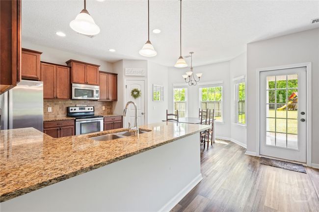 Delightful breakfast area and chandelier lighting. | Image 16
