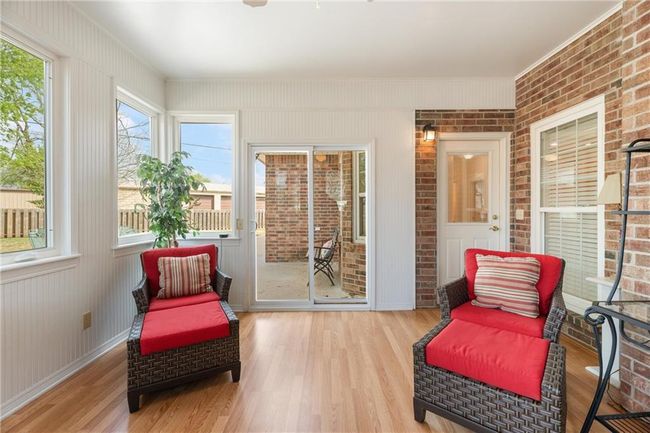 Sunroom / solarium featuring wood finished floors | Image 28