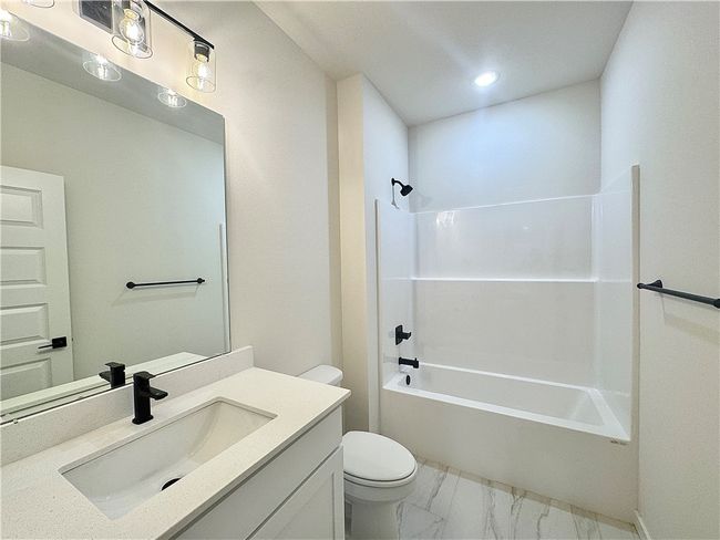The secondary bathroom is a sleek and modern space, featuring elegant finishes and fixtures, providing a comfortable and functional design for everyday use. | Image 16