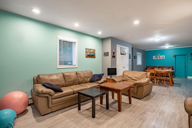 Living room with light wood finished floors and recessed lighting | Image 24