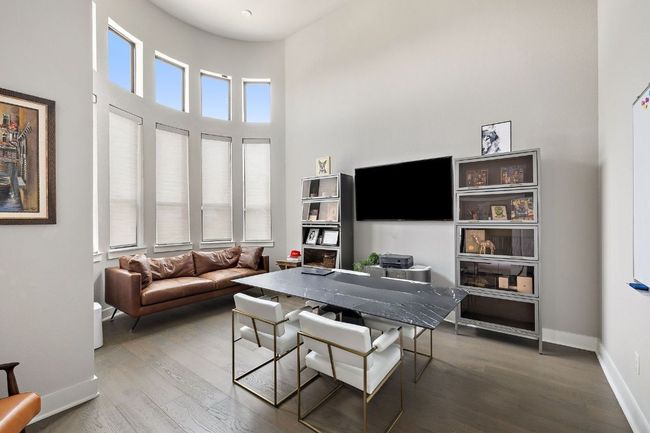 Dining area featuring wood finished floors, baseboards, and a towering ceiling | Image 20
