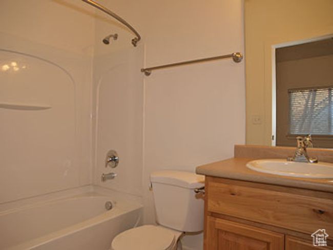 Full bathroom with washtub / shower combination, vanity, and toilet | Image 8