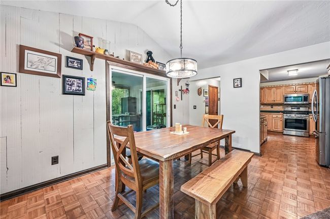 Enjoy your meals in this inviting dining area with natural light. | Image 12